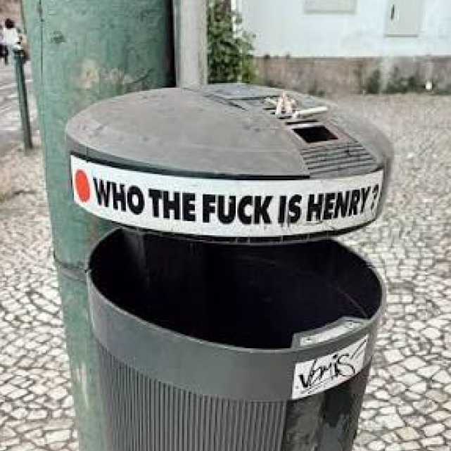 'Who the fuck is Henry?' sticker on a public bin