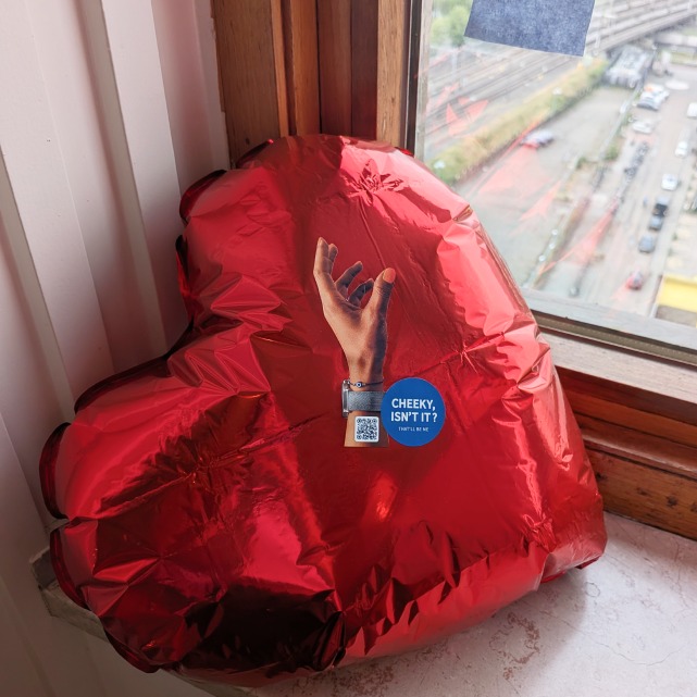 A campaign sticker placed on a red beanbag during the night