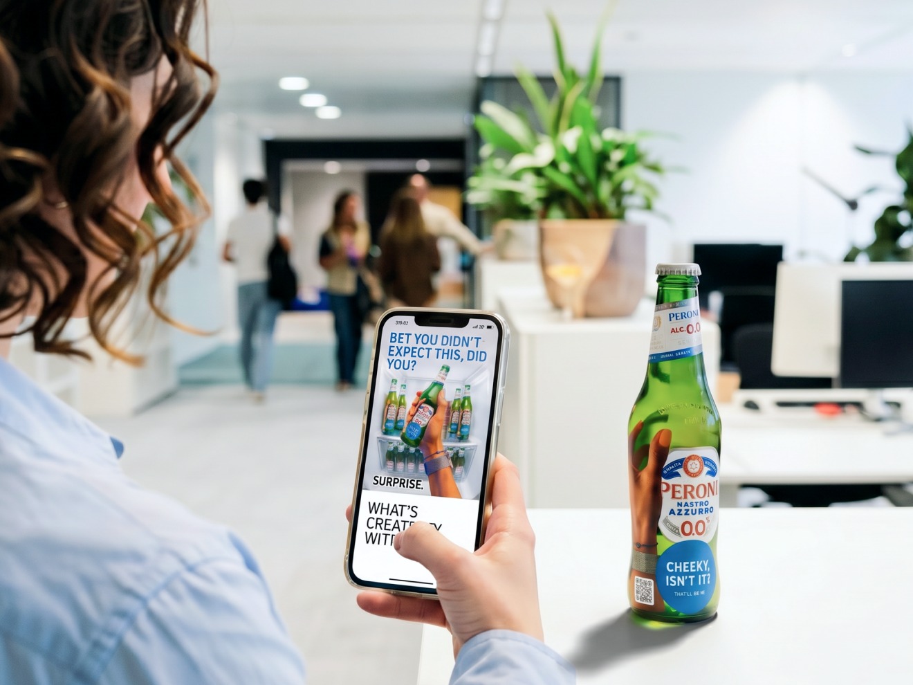 A visitor scanning the sticker's QR code on a Peroni in the fridge