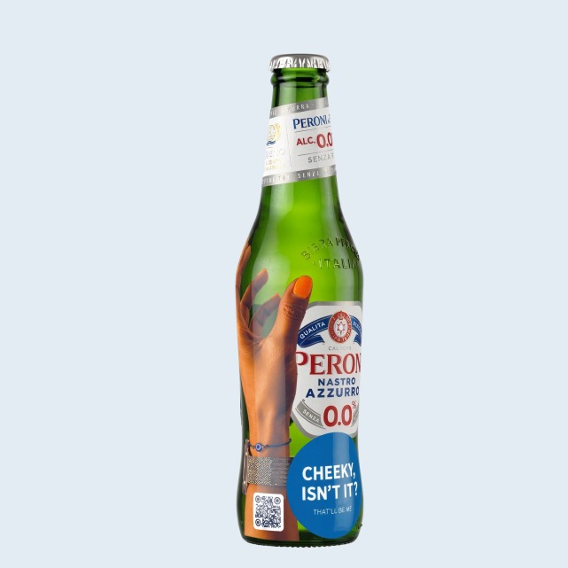 A Peroni bottle wearing the 'Cheeky, isn't it?' sticker