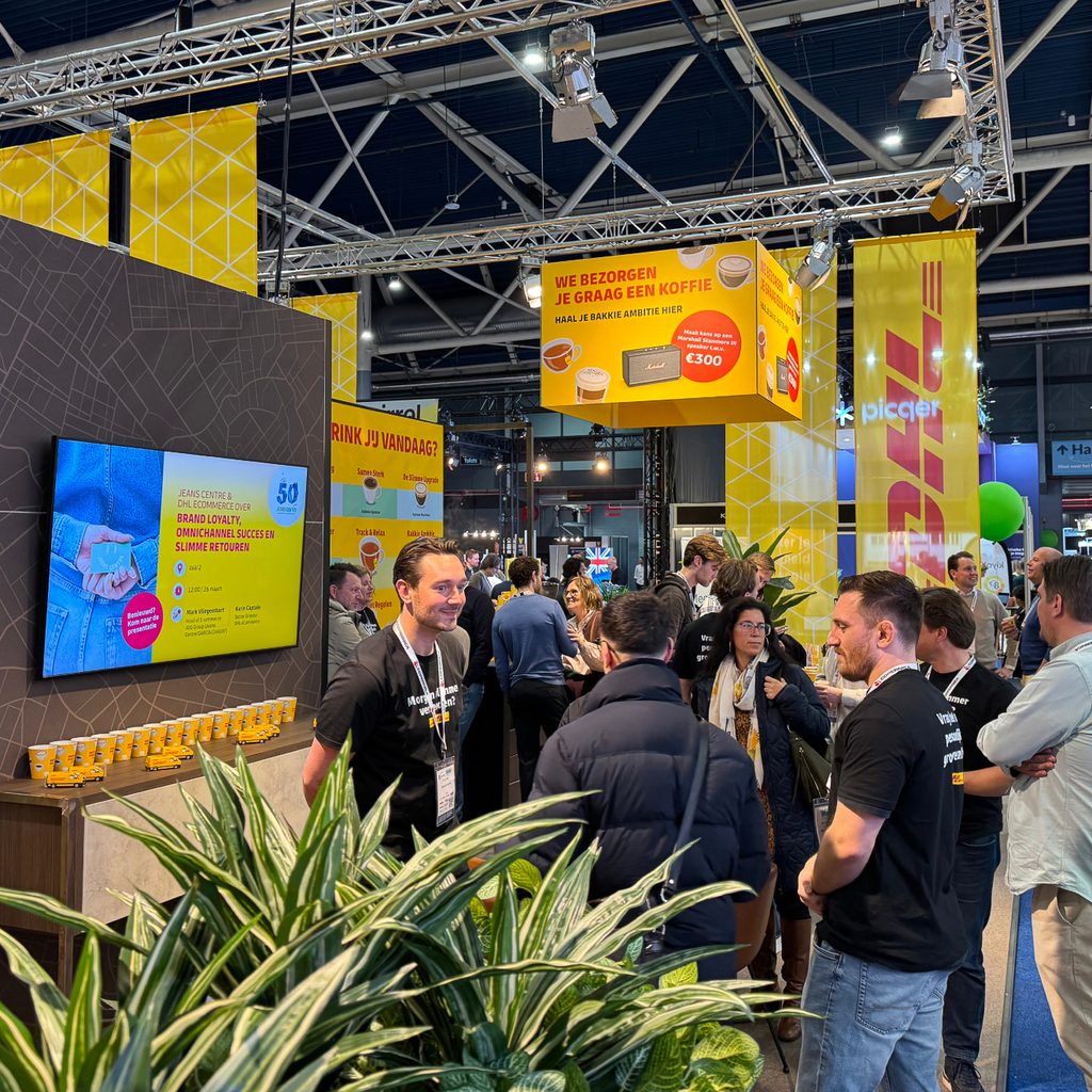 The DHL stand on the fair floor, overhead signage above the crowd